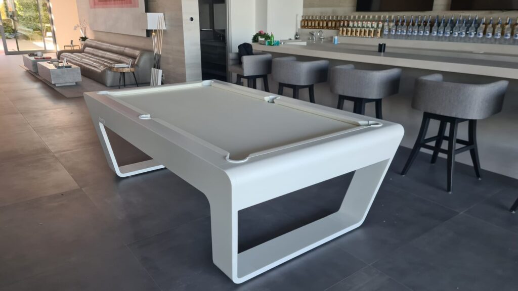 White 724 billiard table displayed in a modern bar and lounge interior at La Quinta.
