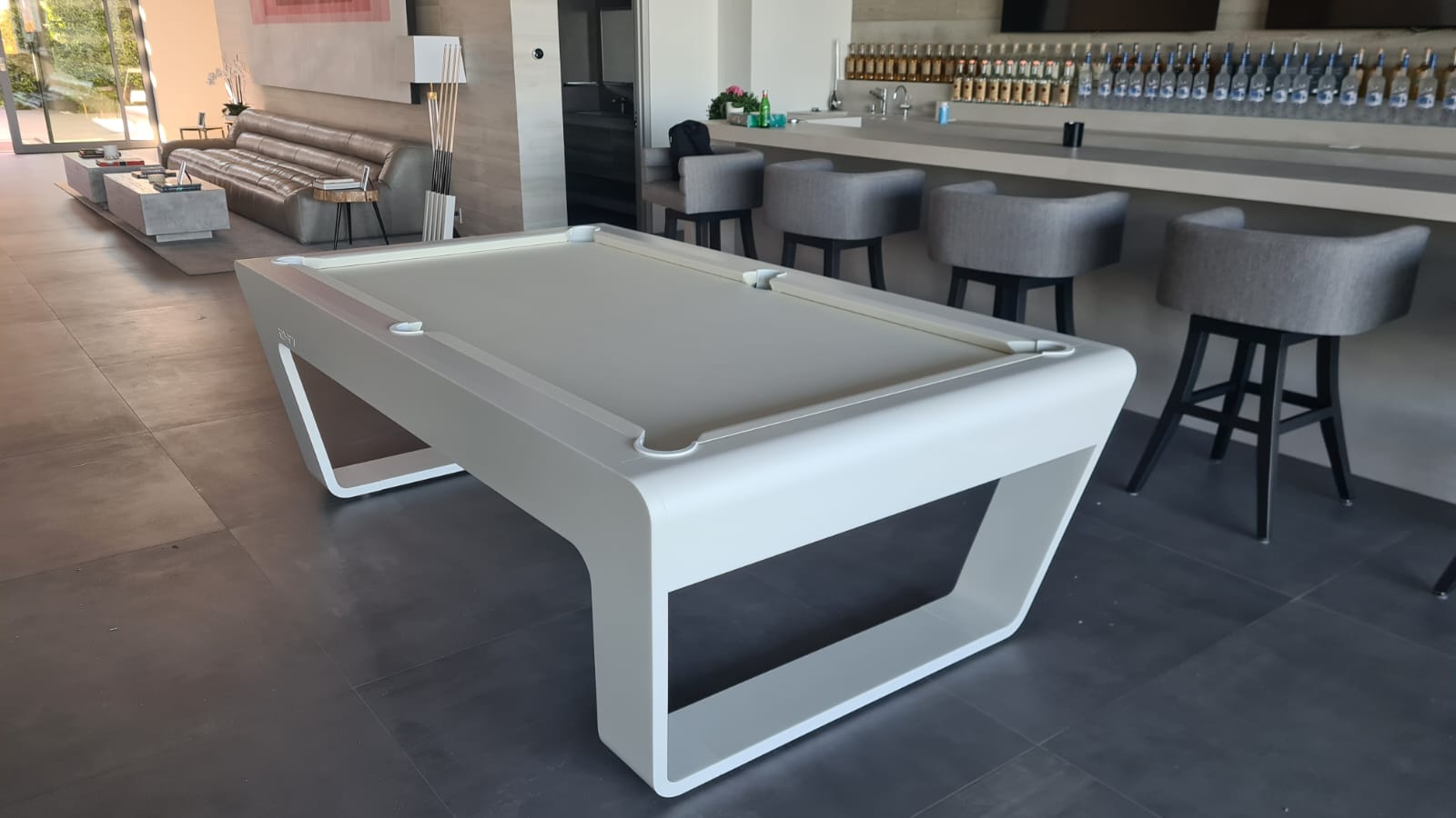 White 724 billiard table displayed in a modern bar and lounge interior at La Quinta.
