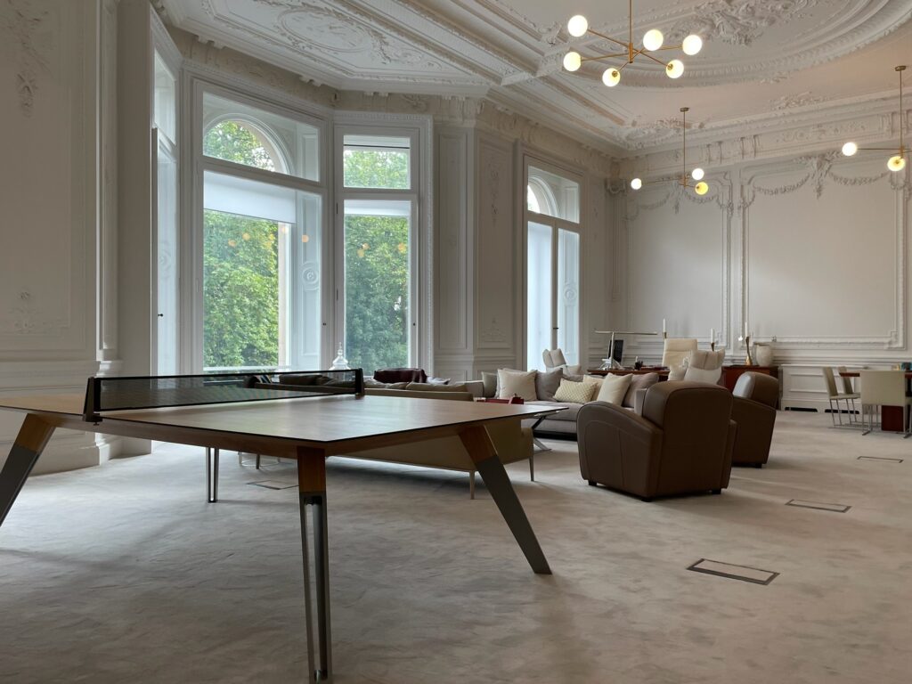 724 table tennis table placed in an elegant London penthouse living space with large windows.