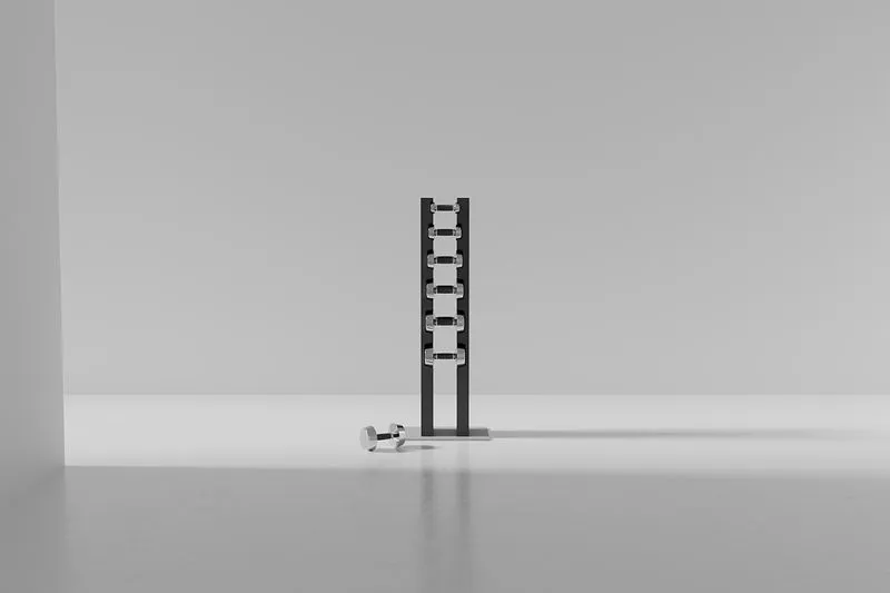 Minimalist display of a black dumbbell stand with a dumbbell on a light studio floor.