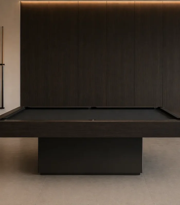 Dark modern pool table in a premium contemporary living room with warm ambient lighting and wood-paneled walls.