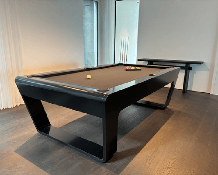 Modern black pool table with billiard balls in a stylish contemporary interior.